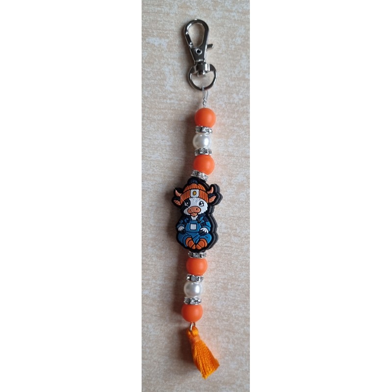 Schlüsselanhänger Kuh mit Mütze orange